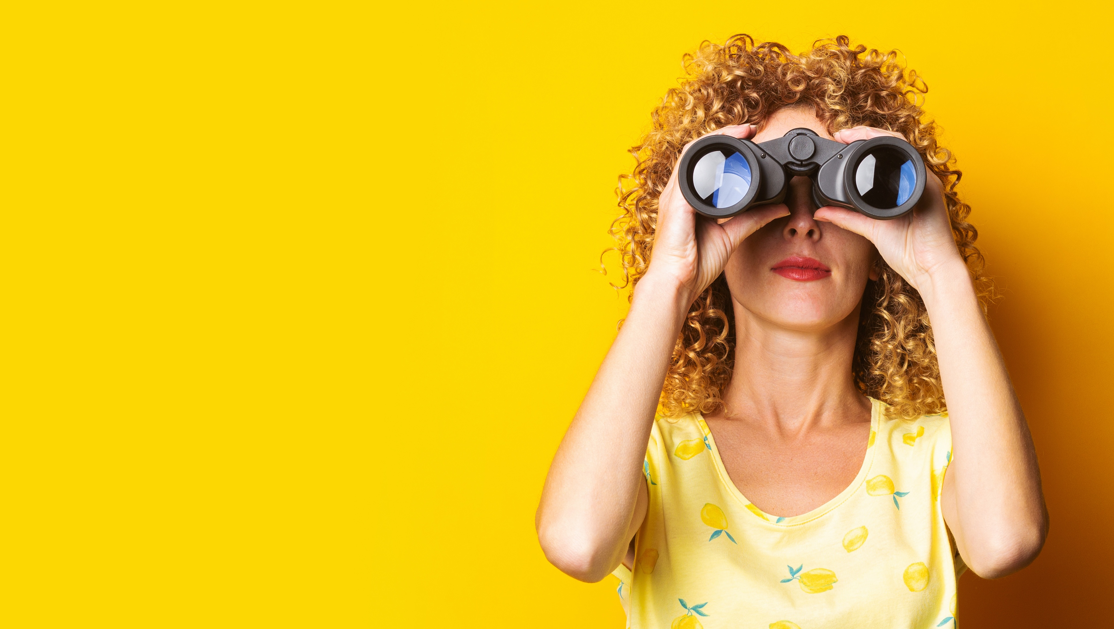 A woman looking through binoculars